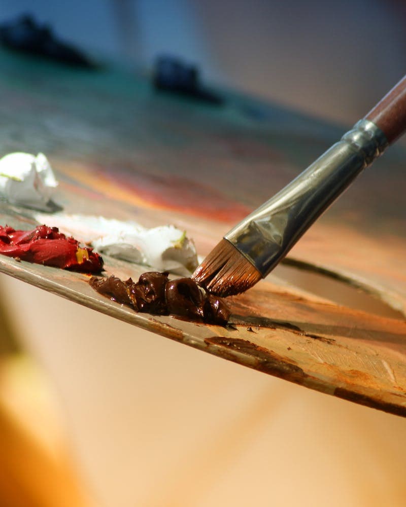 Paintbrush and oil paints on an artist palette